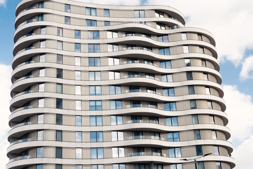 Modern wavy architecture under a bright afternoon sky, capturing dynamic urban design.