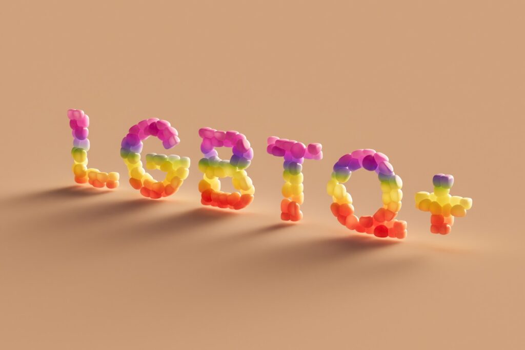 LGBTQ+ letters on a pastel background